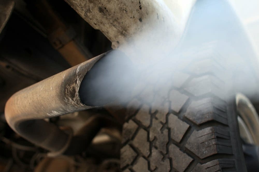 Exhaust flows out of the tailpipe of a vehicle.