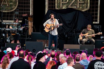 A band performing on an outdoor stage