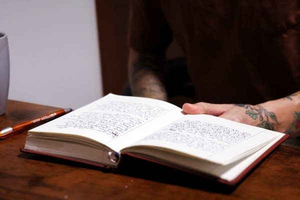 a person flipping through pages of a book