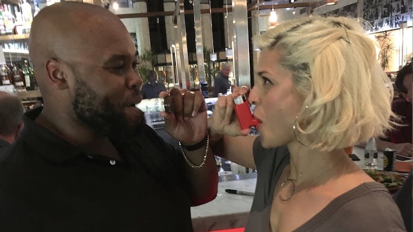 Tuba player Jason Tanksley and Dessa use their inhalers.