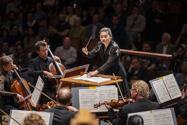 Poster A conductor leads an orchestra during a concert