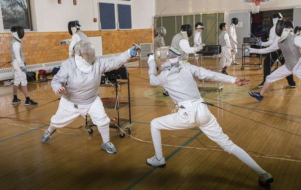 Instructor and fencing coach, Corlis Hicks, left, spars with a student.