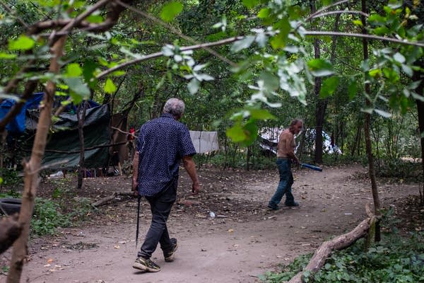 A man walks with a machete
