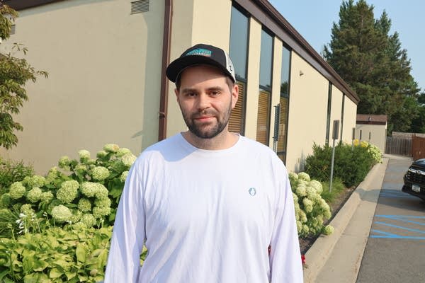 A man stands outside of a building.