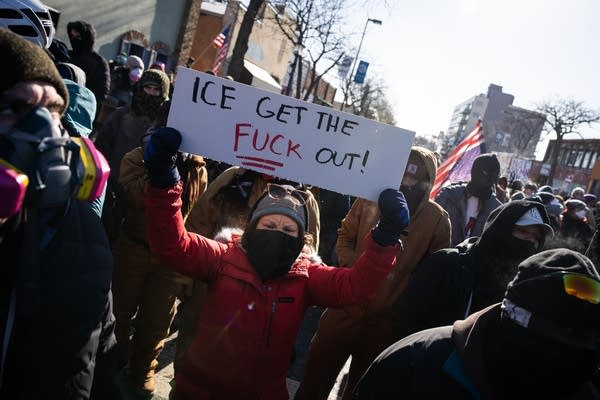 a person holds a sign