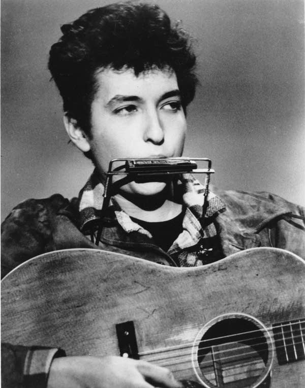 Bob Dylan plays the harmonica and acoustic guitar in March, 1963.