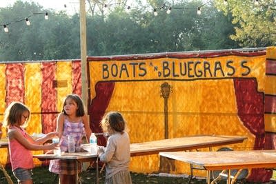 Some kids enjoy a snack at a table during a music festival in Winona, Minnesota.
