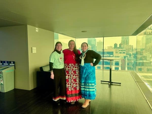 Three people pose for a photograph.
