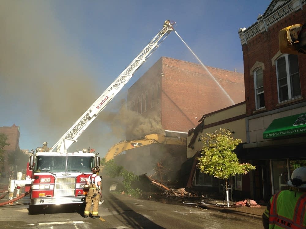 Fire crews and demolition equipment