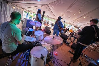 clare doyle and her band performing under a tent 05