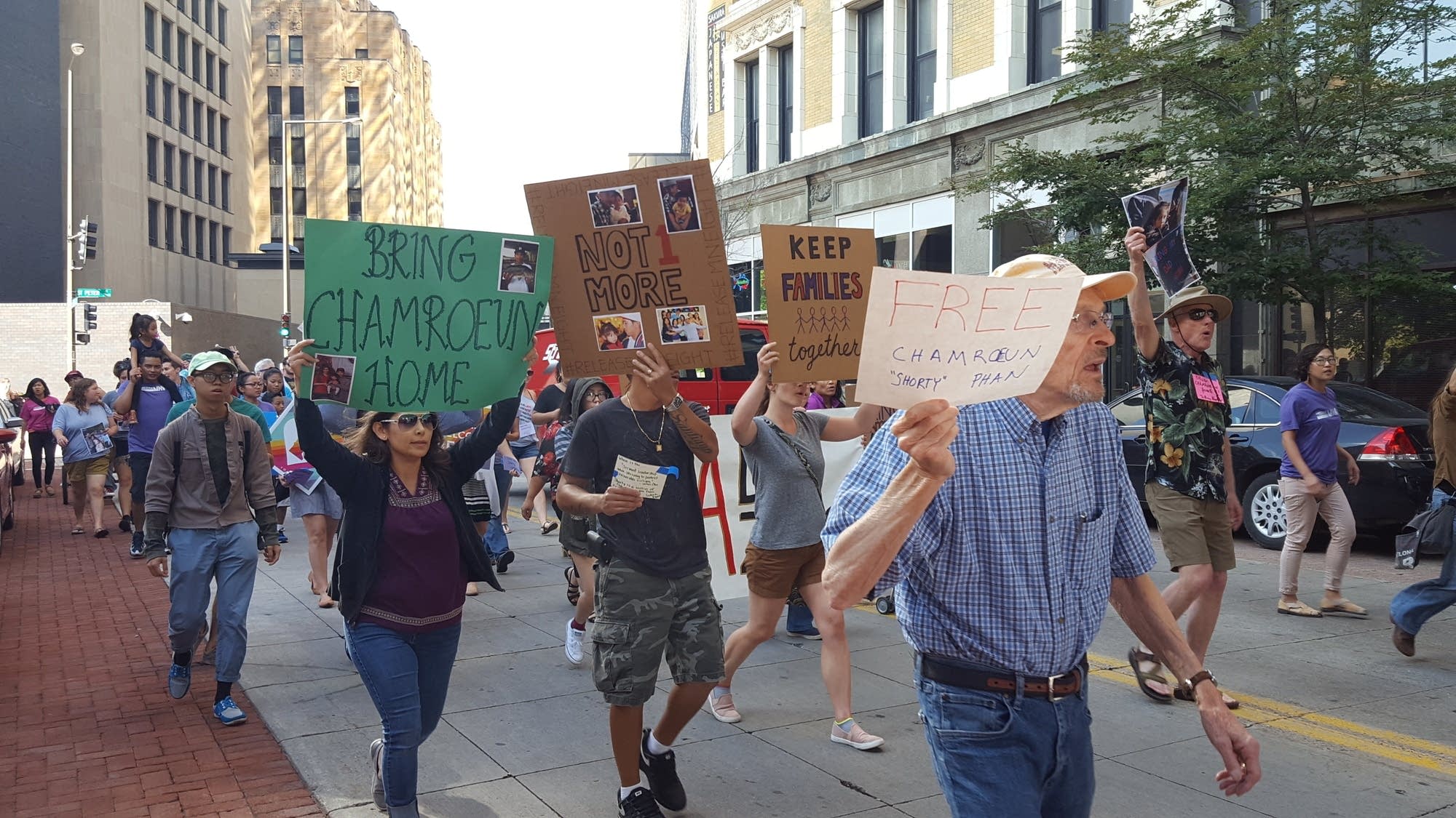 Immigrant rights supporters march with a group called Minnesota 8