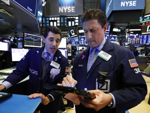 Traders work on the floor of the New York Stock Exchange.