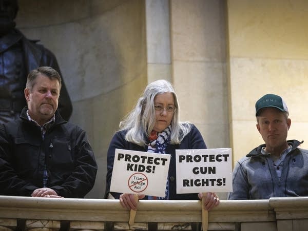 A woman holds signs 