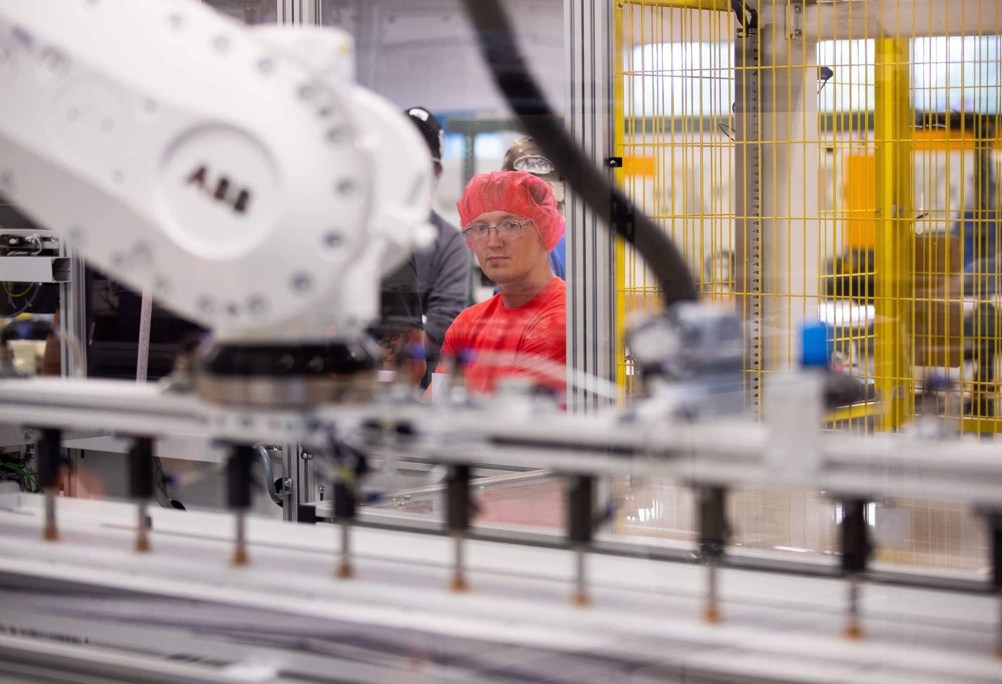 Alan Oferosky watches an automated machine solder bus wire