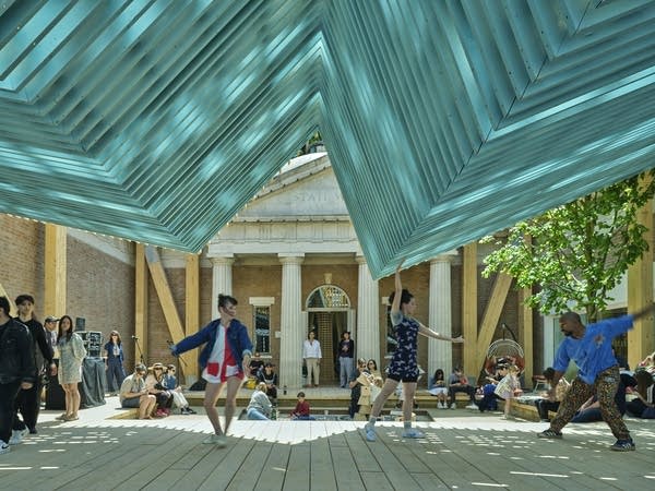 A brown porch with blue beams at the top