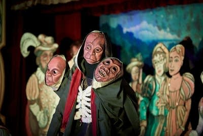 An array of puppets performing onstage
