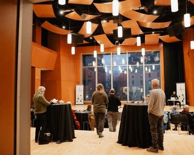 People gather and converse at a social event