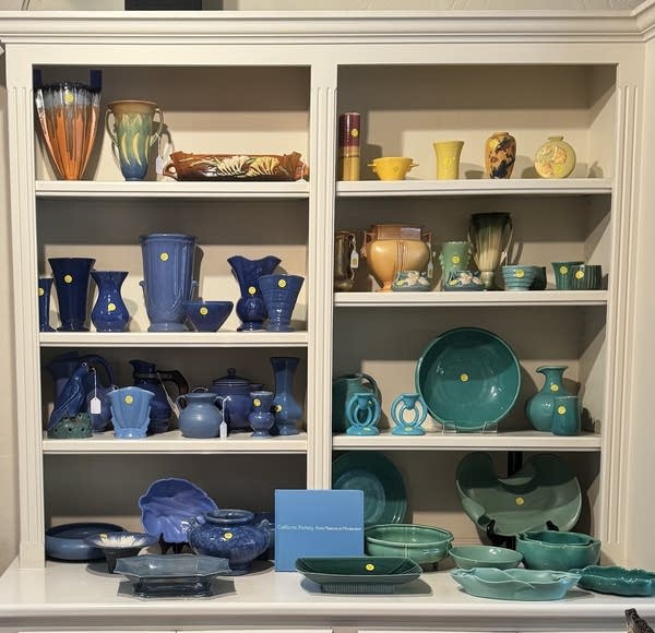 Ceramics of different colors on shelves