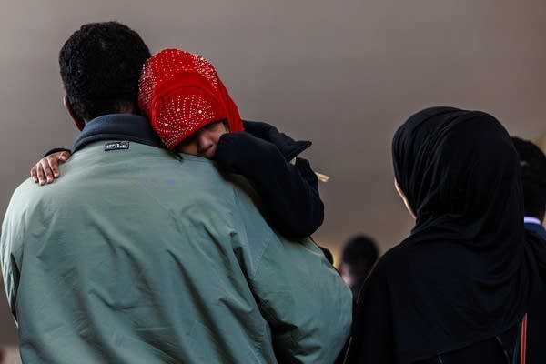 A father holds onto his daughter