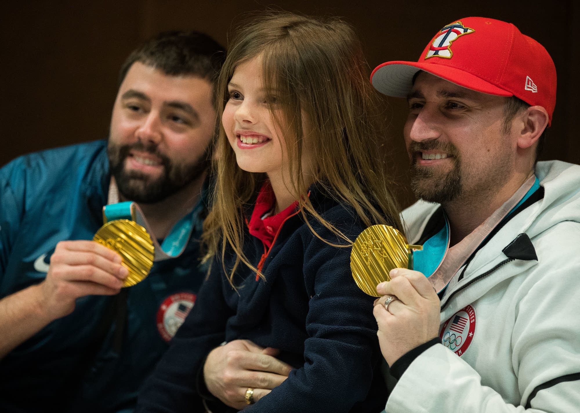 Kate Kubat poses for a picture with John Landsteiner, left, and Joe Polo.