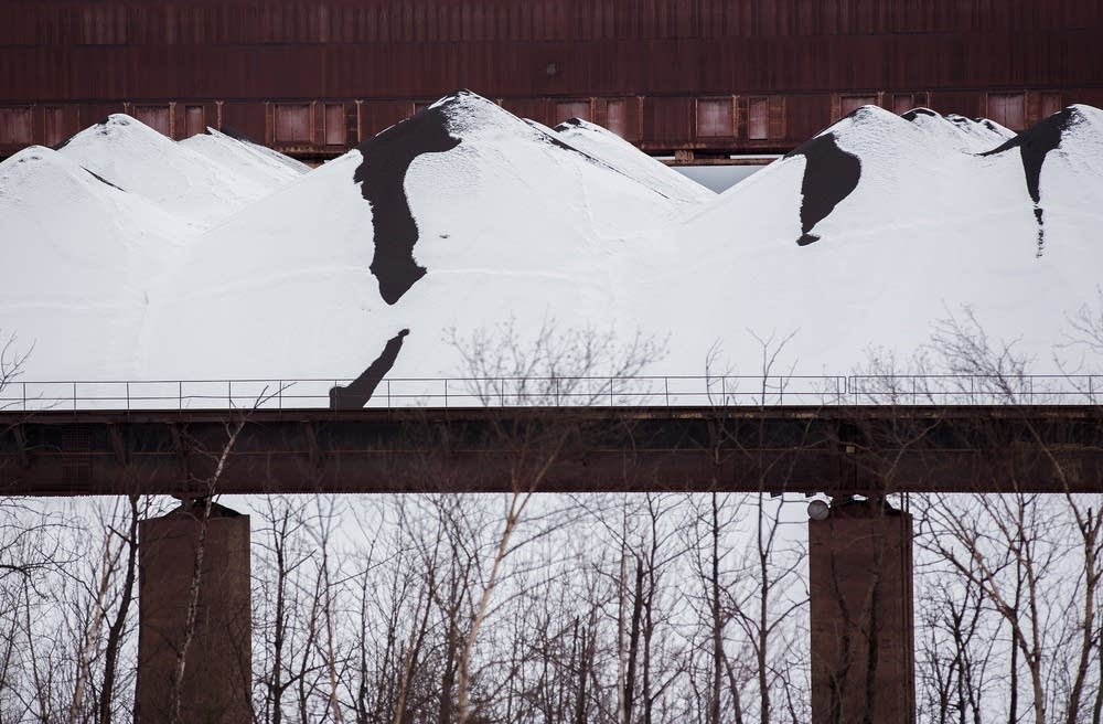 A pile of taconite is covered by snow.
