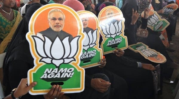 Indian Muslim supporters of the Bharatiya Janata Party (BJP) hold pictures of Prime Minister Narendra Modi at a rally held by party president Amit Shah ahead of the national elections in Hyderabad on April 9, 2019.