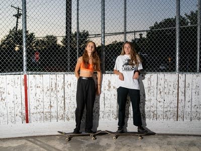 Two skaters stand for a portrait. 