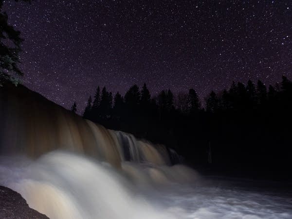 The middle falls at Gooseberry Falls State Park flow under a clear night sky Tuesday, April 9, 2019 near Castle Danger, Minn.