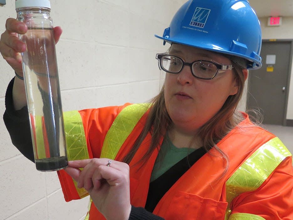 Sarah Lerohl holds an example of cleaned water