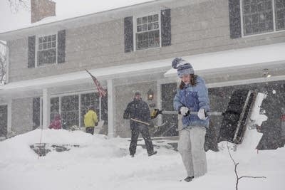 Maggie Farley, 10, shovels the driveway with her dad, Dan, and siblings.