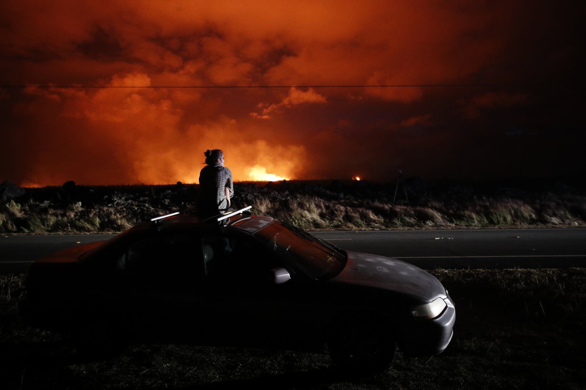 Brittany Kimball watches as lava erupts from a fissure.