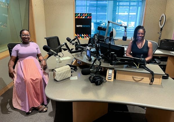 two women smiling in broadcast studio