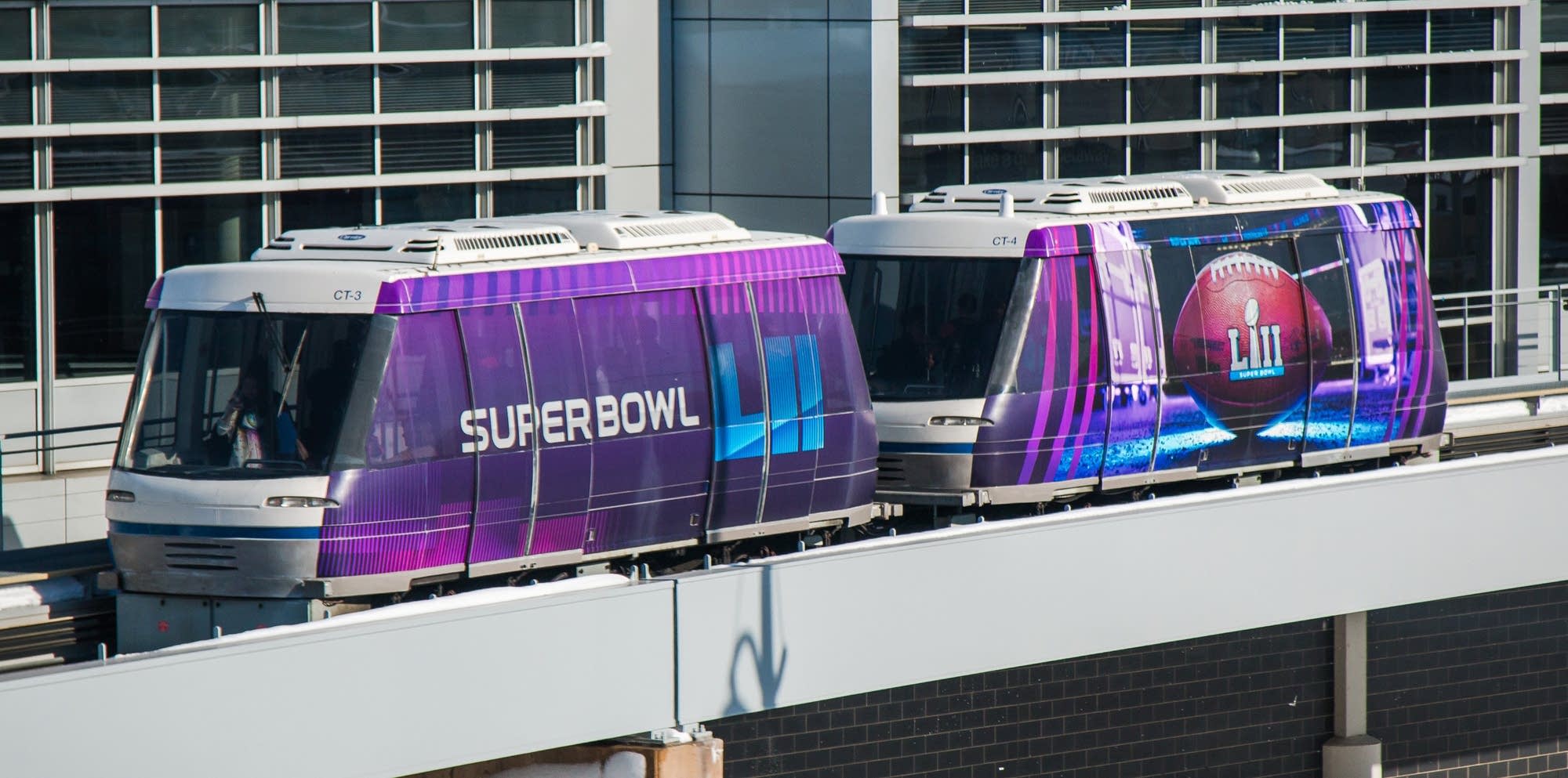 An airport tram advertising the Super Bowl.