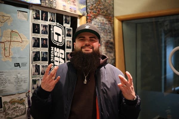 man poses for photo while making w's with his fingers
