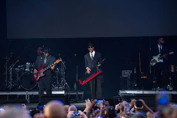 Jimmy Jam and Terry Lewis perform on an outdoor stage.