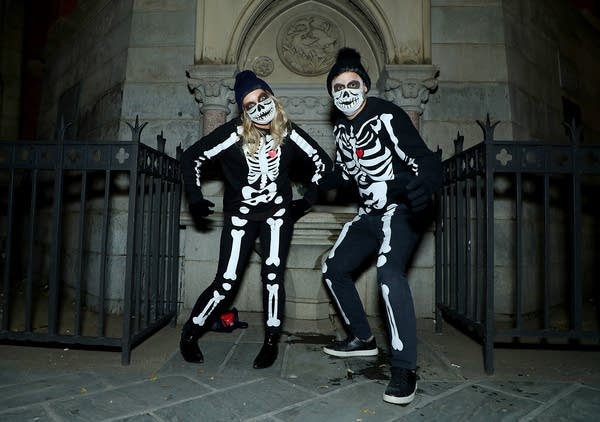 People wear ghostly skeleton costumes on October 31, 2020 in New York City.