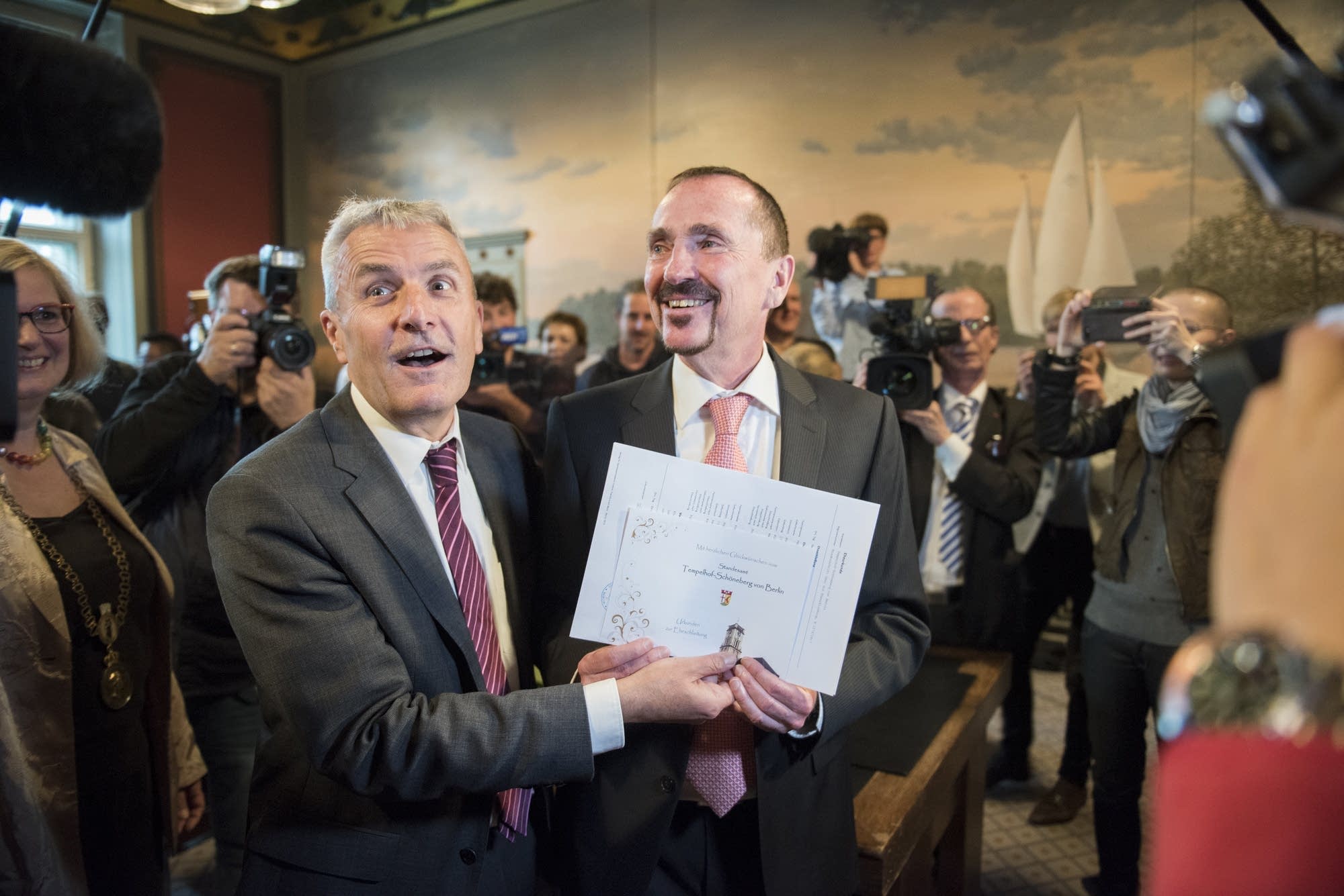 Karl Kreile (right) and Bodo Mende cheer after their wedding.