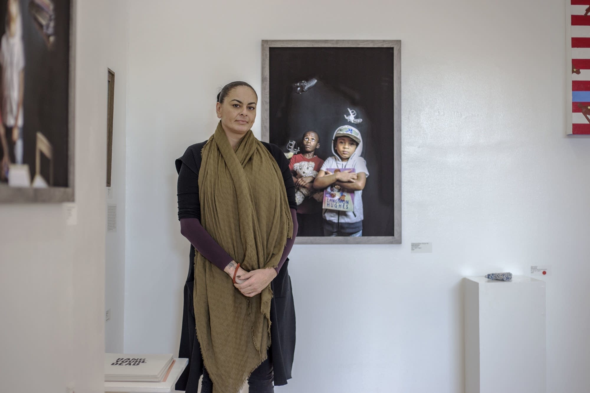 Nikki McComb poses next to her work at Gamut Gallery.