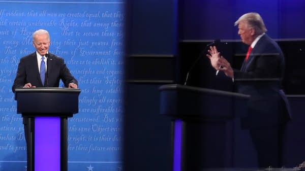 President Donald Trump is shown in a reflection while Democratic presidential nominee Joe Biden listens in the final presidential debate at Belmont University on Oct. 22 in Nashville, Tennessee.