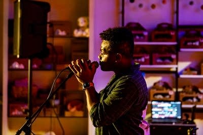 A musician sings onstage in a music venue