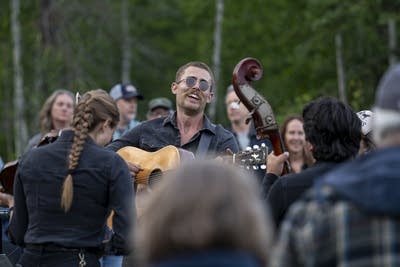 the band wild horses performing among a crowd of people