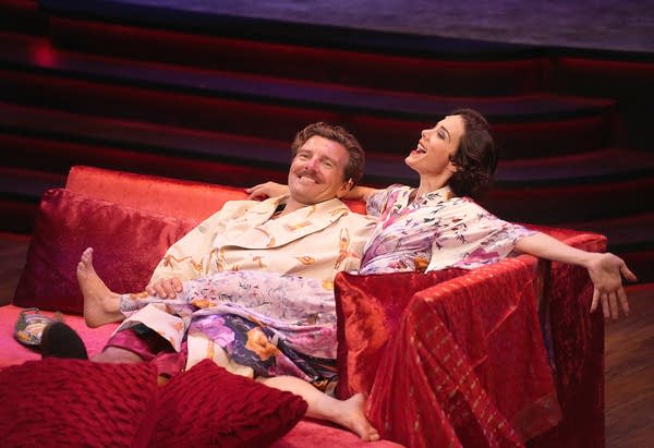 Two people sitting down on couch