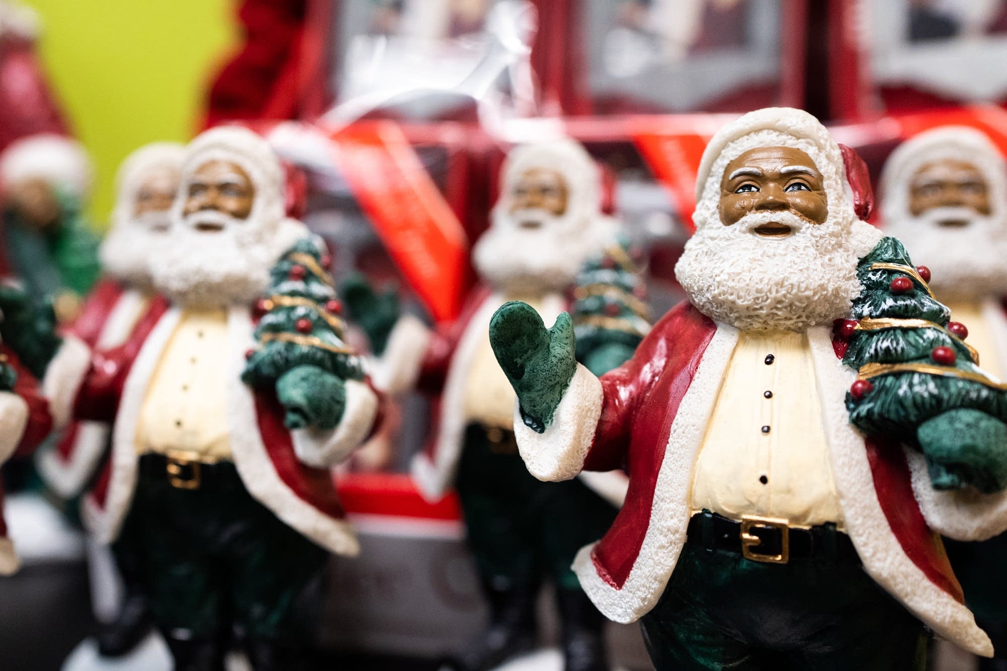 Tiny replicas of Santa Larry Jefferson sit on a shelf.