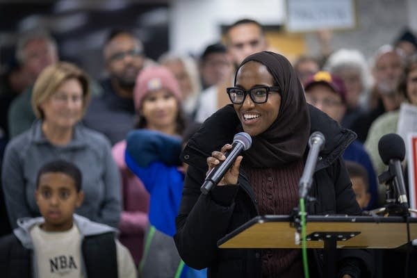 A woman speaks at a press conference