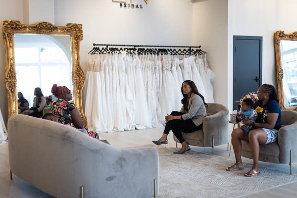 Women sit in a bridal shop