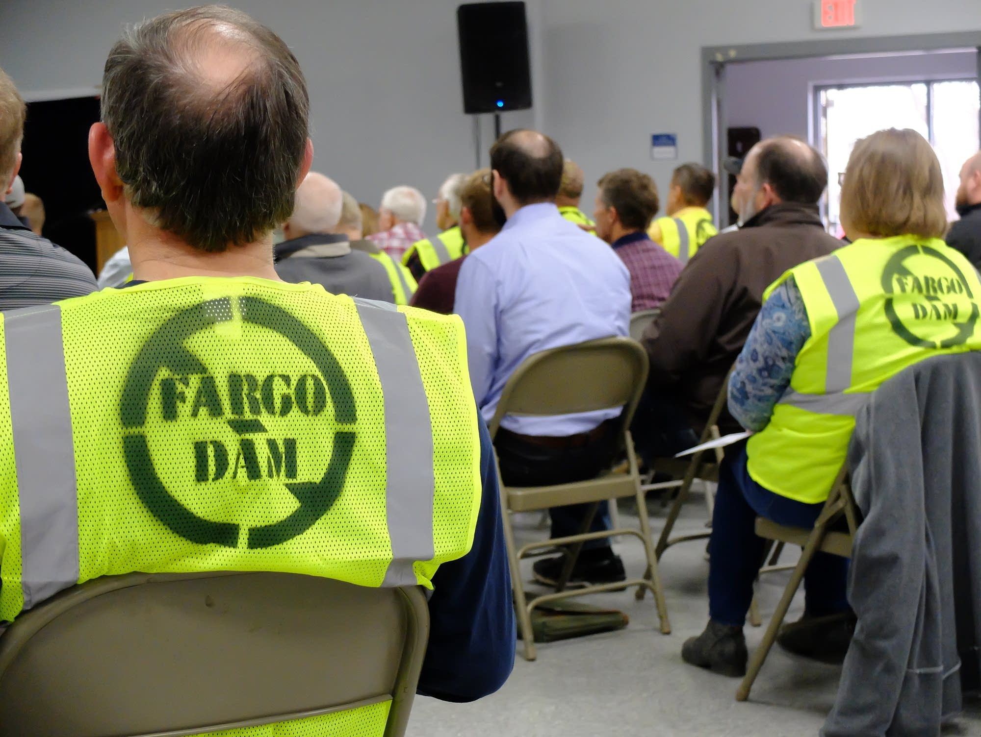 Opponents of the Fargo Moorhead diversion project wear construction vests.