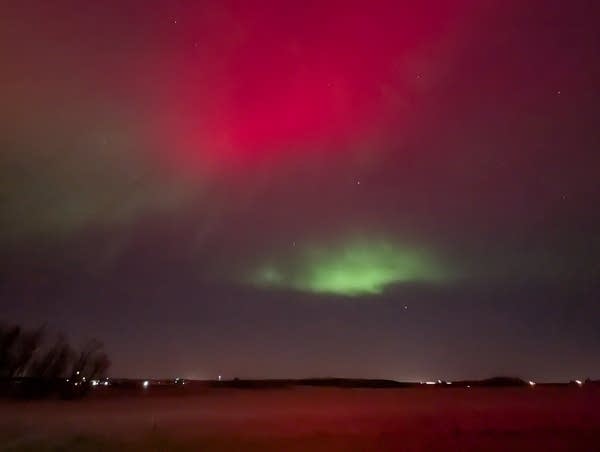 Green and red lights in the night sky.