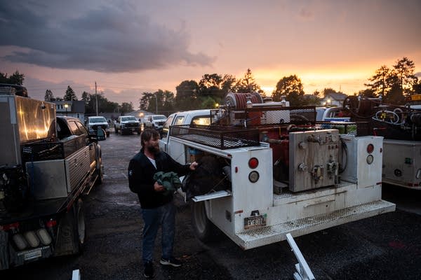 A man packing gear into a truck