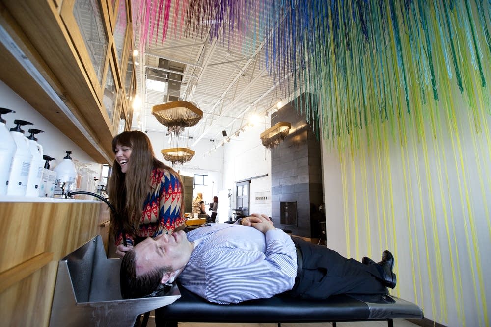 Caitlin Dvorak washes customer's hair
