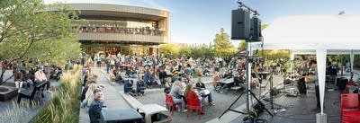 Panoramic view of the stage, crowd, and brewery building